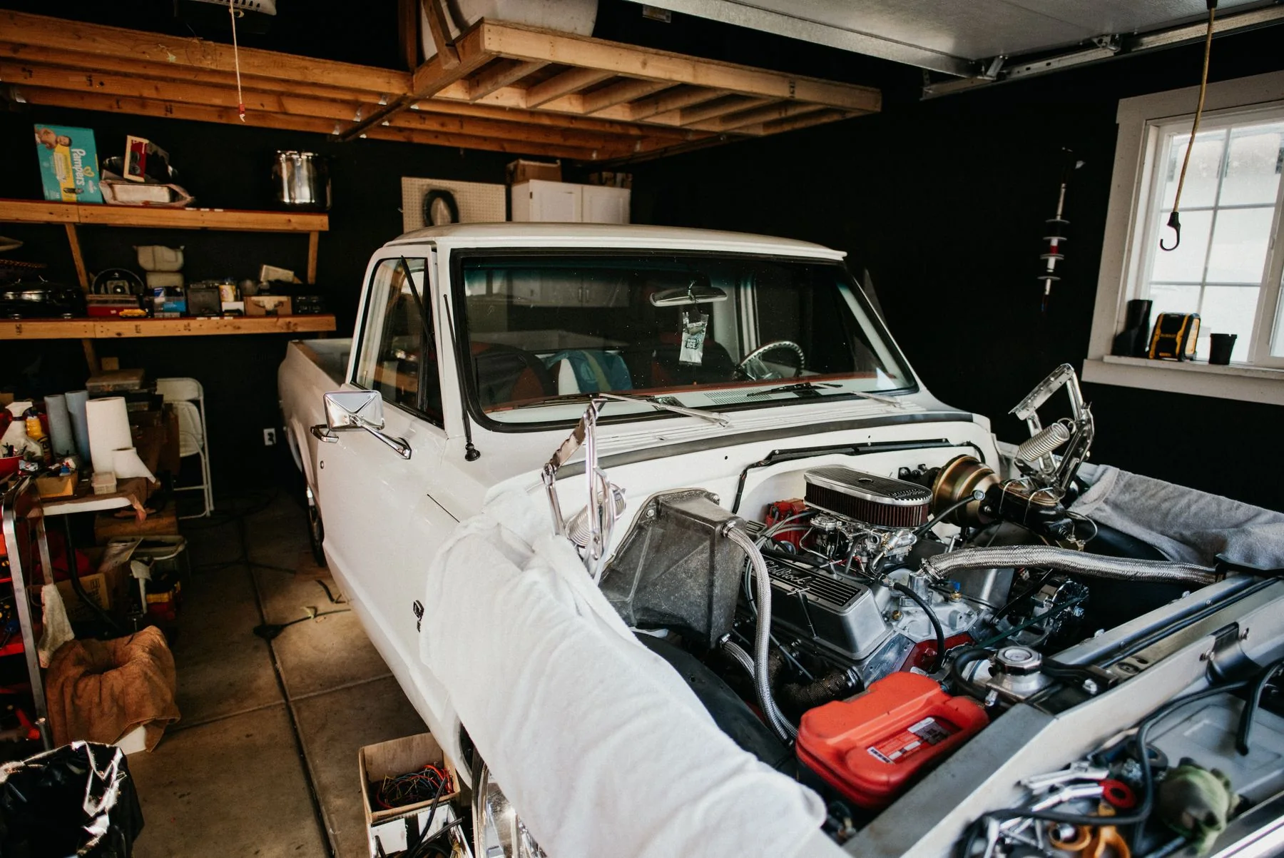 Classic project vehicle with its engine bay open for workshop work