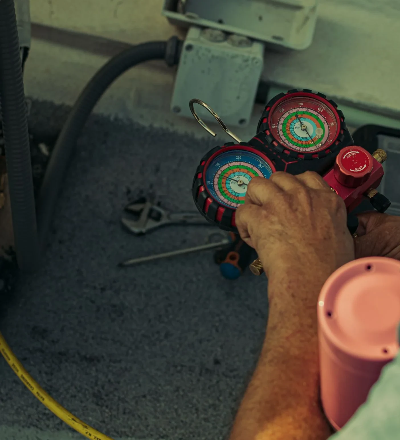 Refrigerant manifold gauges being used during air conditioning diagnosis